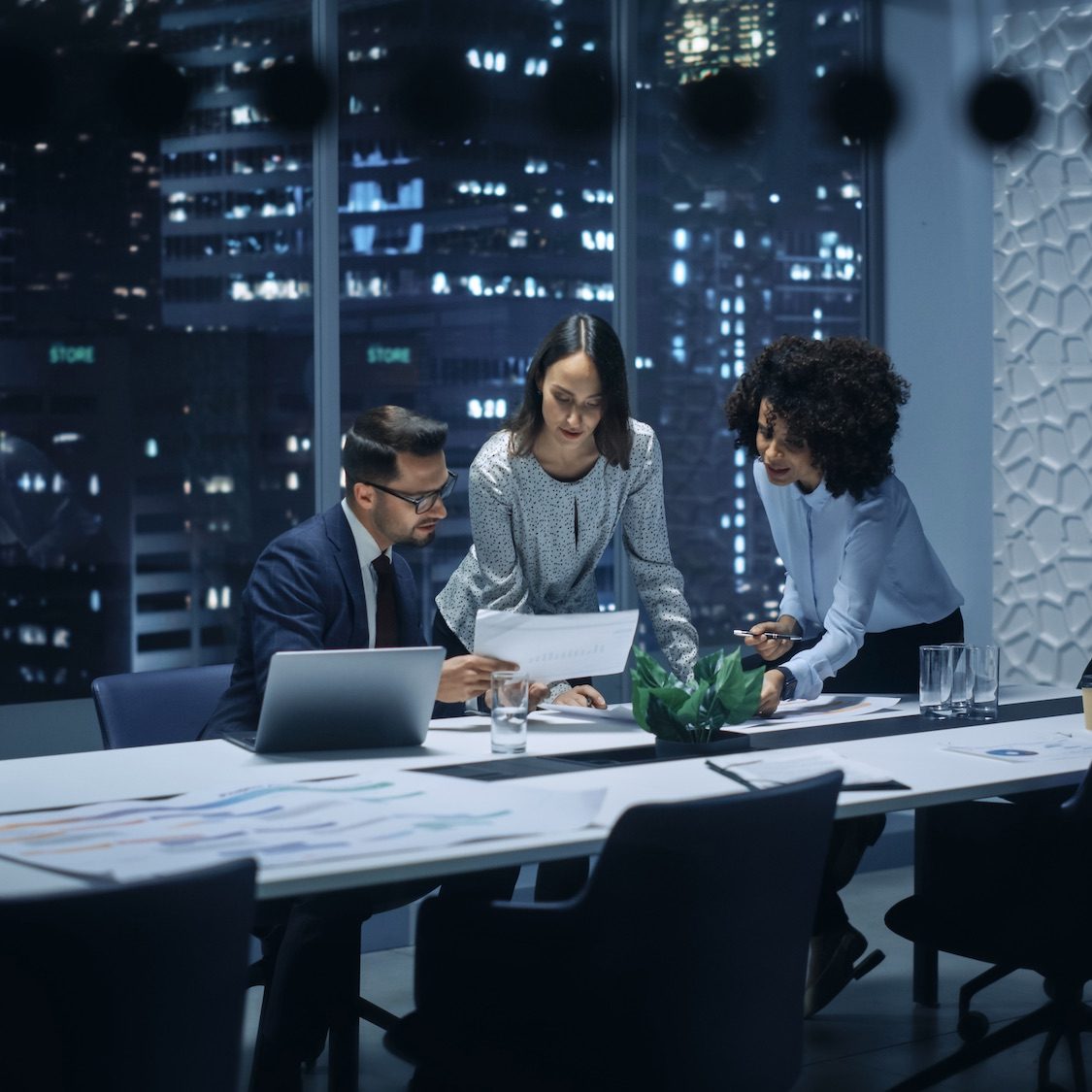 Office Conference Room Meeting: Diverse Team of Top Managers Talk, Discuss, Brainstorm, Use Laptop Computer. Business Partners Presenting Investment and Marketing Strategy for E-Commerce Startup.